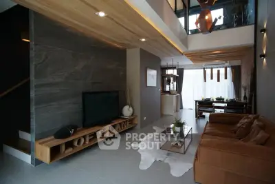 Modern loft-style living room with high ceilings and stylish decor