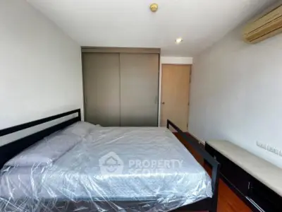 Spacious bedroom with modern design and ample storage in a prime real estate location.