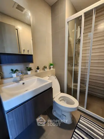 Modern bathroom with sleek fixtures and glass shower enclosure