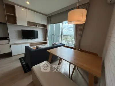 Modern living room with stylish furniture and large window offering a stunning city view.