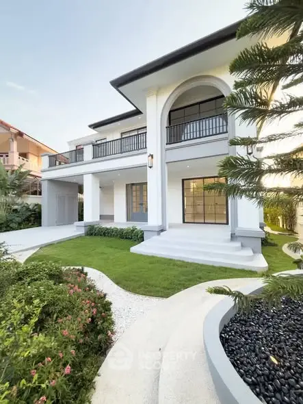 Elegant two-story house with manicured garden and modern architecture