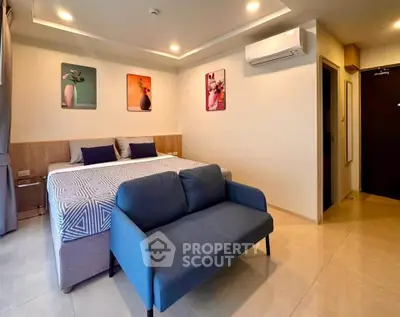 Modern bedroom with stylish decor and cozy seating area