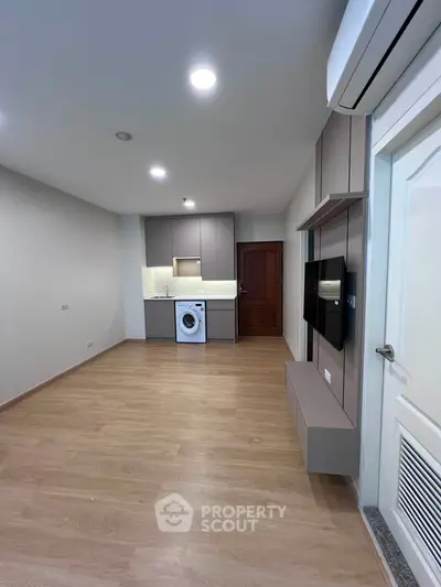 Modern apartment interior with sleek kitchen and washing machine