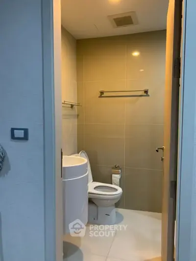 Modern compact bathroom with sleek fixtures and neutral tones