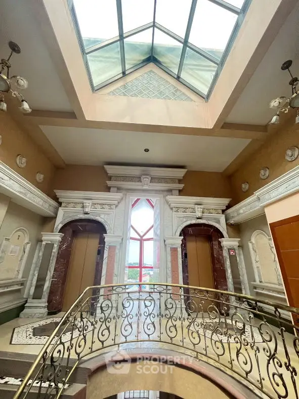 Luxurious building entrance with elegant marble and ornate railing