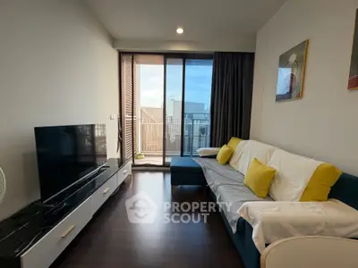 Modern living room with balcony view, stylish decor, and natural light.