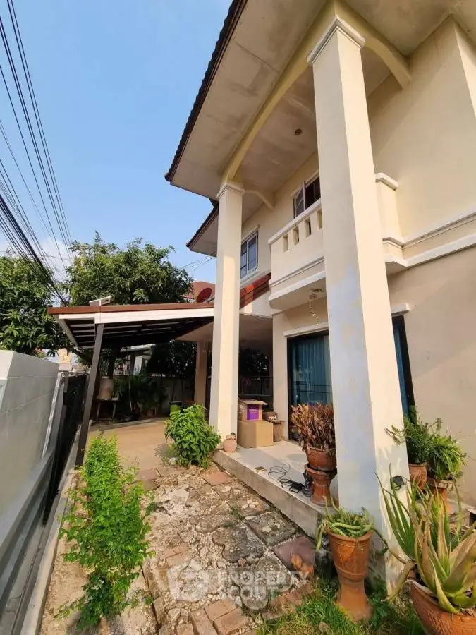 Charming two-story house with spacious garden and covered patio, perfect for family living.