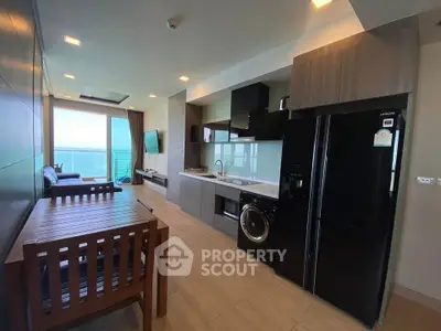 Modern open-layout kitchen with ocean view and sleek appliances
