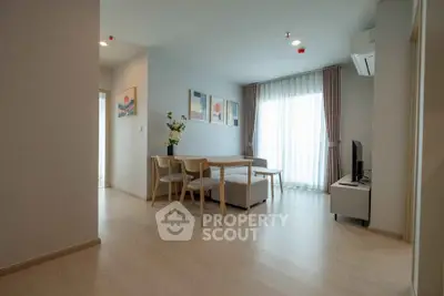 Modern living room with natural light, minimalist furniture, and stylish decor in a cozy apartment.