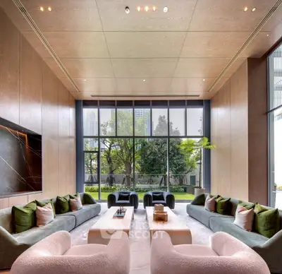 Luxurious modern living room with large windows and garden view, featuring elegant furniture and high ceilings.