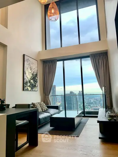 Luxurious high-rise living room with floor-to-ceiling windows and stunning city view.