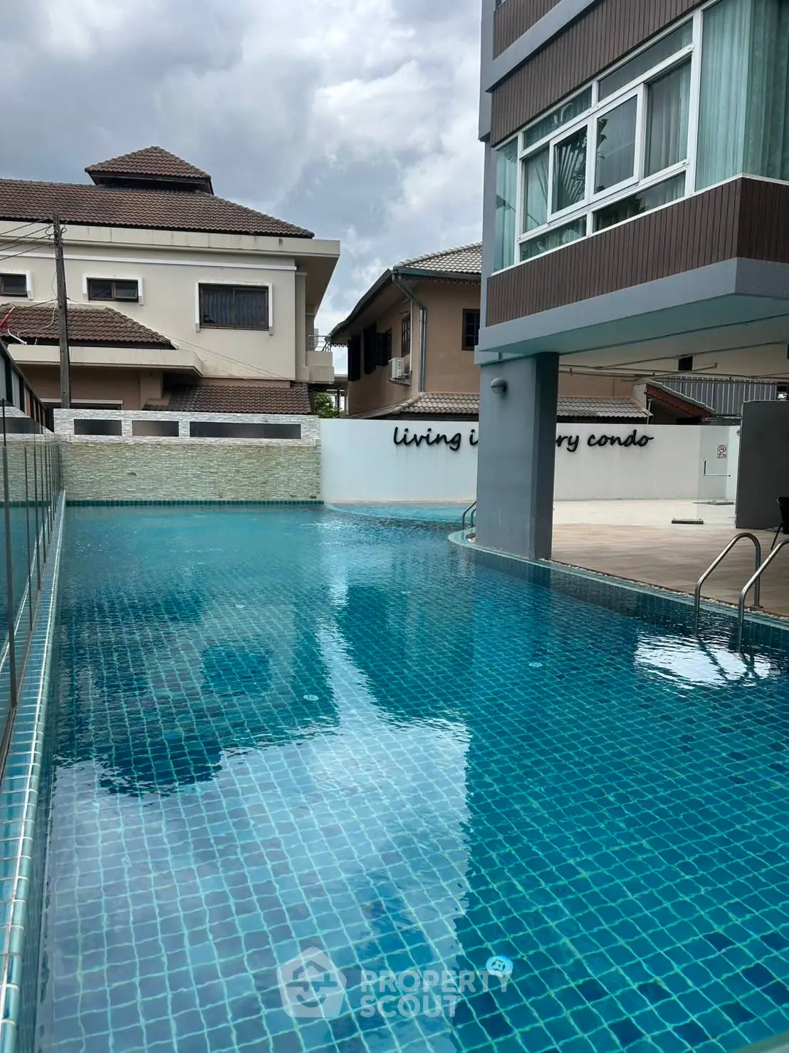 Luxurious condo with a pristine swimming pool and modern architecture, perfect for relaxation and leisure.