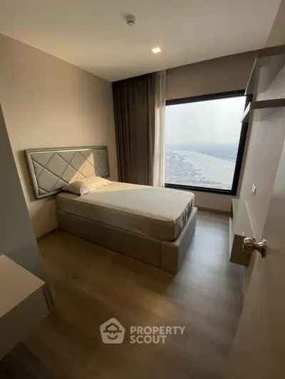 Modern bedroom with stunning river view and elegant decor