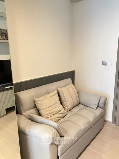 Cozy living room corner with a plush gray sofa and modern decor