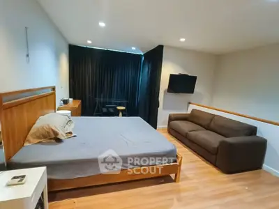 Spacious bedroom with modern furnishings and cozy ambiance