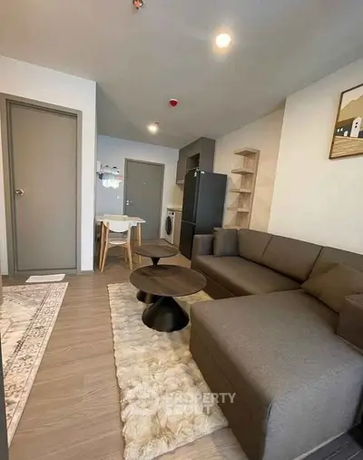 Modern living room with cozy sectional sofa and stylish decor in a contemporary apartment.