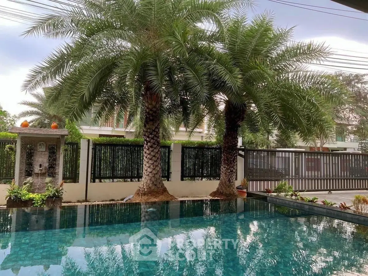 Luxurious private pool with palm trees in a serene residential setting