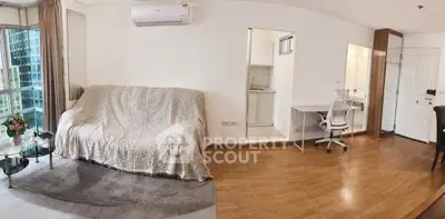 Spacious living room with modern decor and natural light in urban apartment.