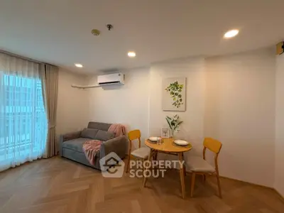 Cozy living room with modern decor and dining area in a stylish apartment.