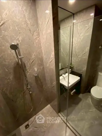 Luxurious marble bathroom with modern shower and sleek fixtures
