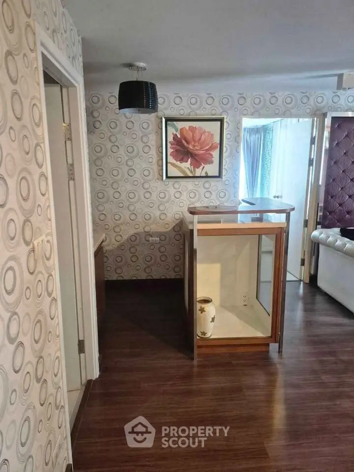 Stylish interior with modern wallpaper and elegant wooden flooring in a cozy living space.