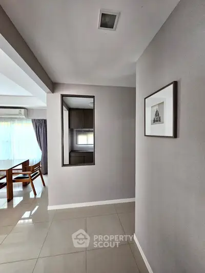Modern apartment hallway with sleek design and natural light