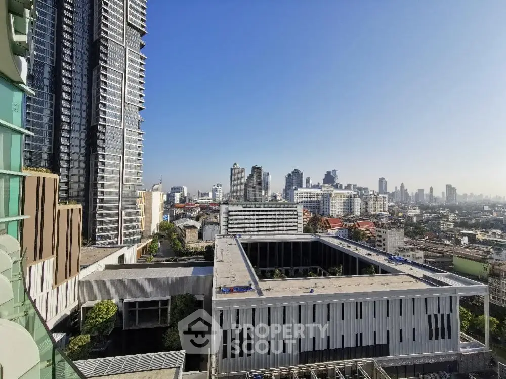 Stunning cityscape view from a high-rise building balcony in urban setting.