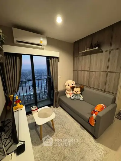 Cozy living room with city view, plush sofa, and modern decor in high-rise apartment.