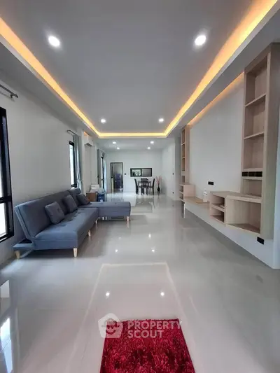 Spacious modern living room with sleek design and ambient lighting