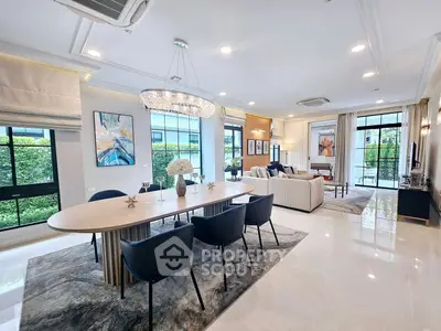 Luxurious open-plan living and dining area with elegant decor and natural light.