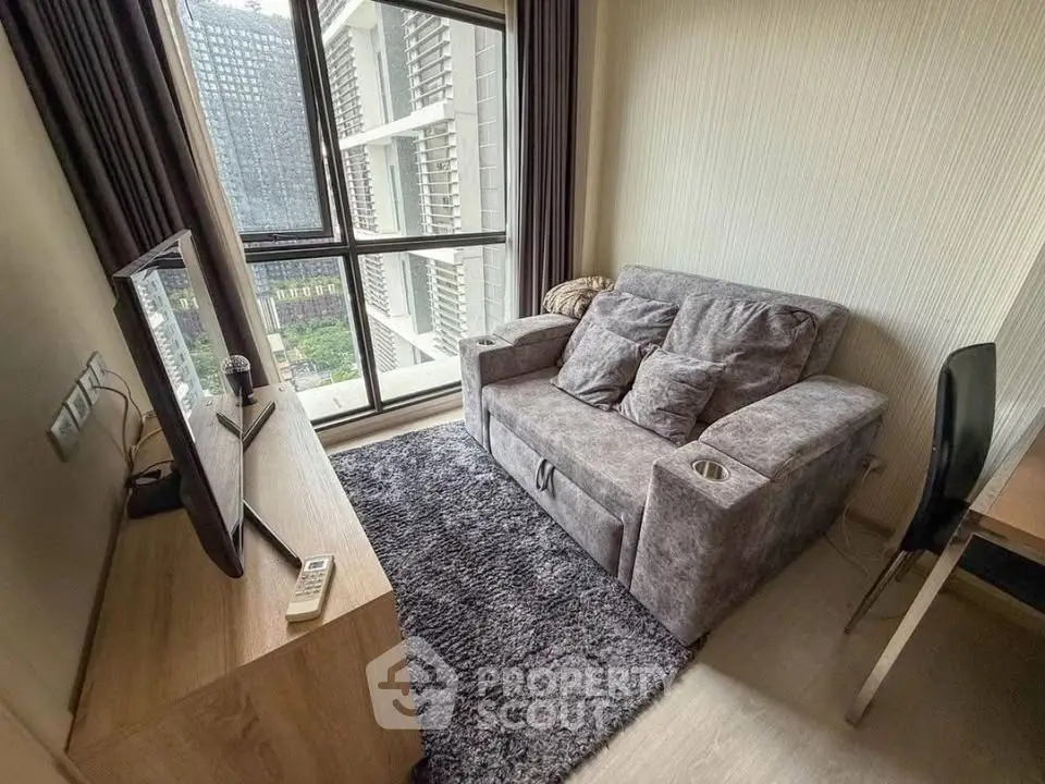 Cozy living room with plush sofa and large window offering city view