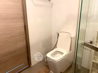 Modern bathroom with sleek toilet and glass shower enclosure