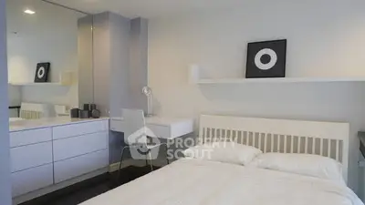 Modern bedroom with sleek white furniture and minimalist decor