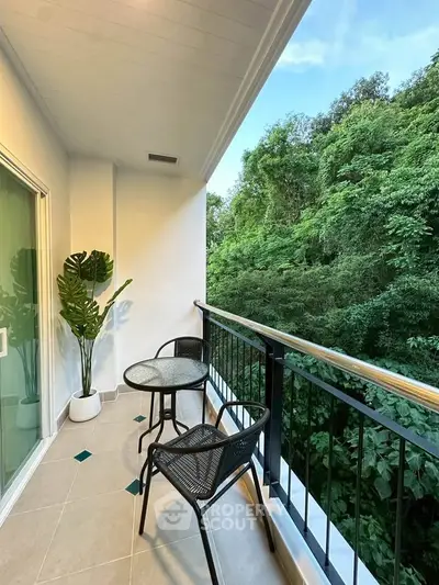 Charming balcony with lush green view, perfect for relaxation and enjoying nature.
