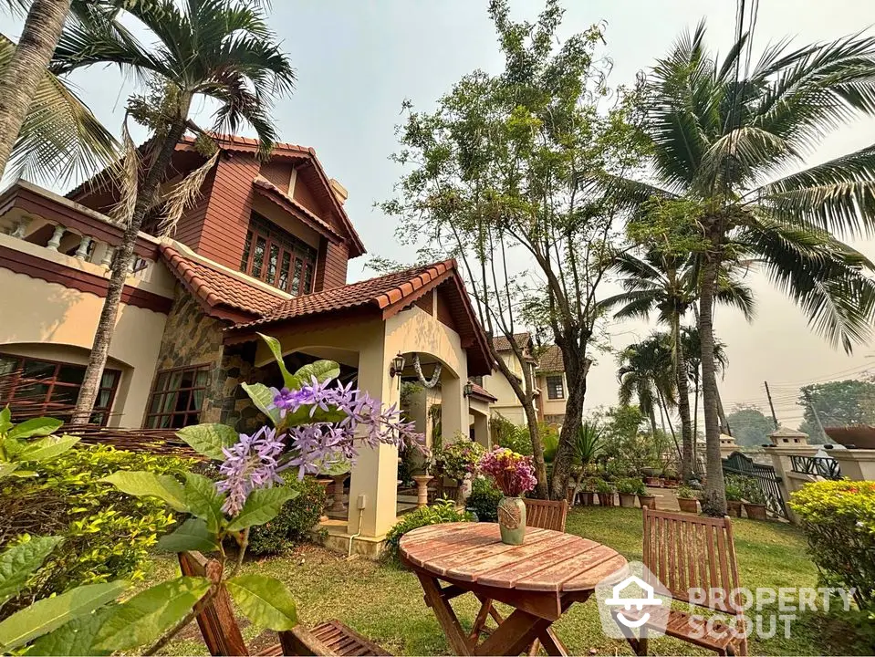 Charming villa with lush garden and outdoor seating, surrounded by tropical palm trees and vibrant flora, showcasing a serene and private living experience.