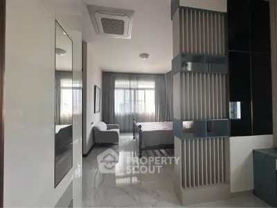 Spacious bedroom with modern design and large windows for natural light