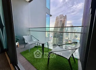 Stunning city view from modern high-rise balcony with stylish seating area.