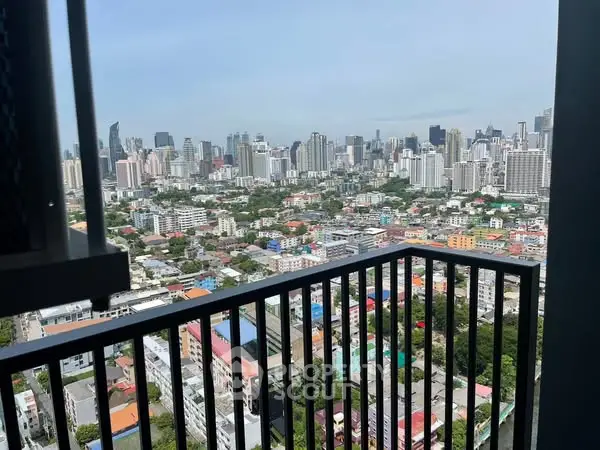 Stunning cityscape view from high-rise balcony in urban setting.