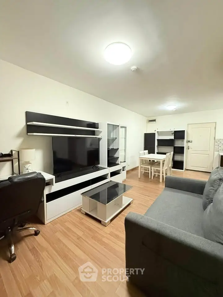 Modern living room with sleek furniture and wooden flooring, perfect for cozy gatherings.