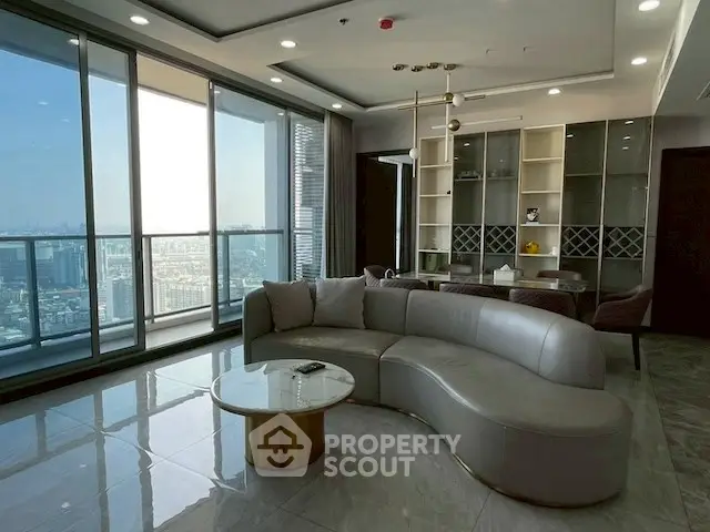 Luxurious high-rise living room with panoramic city views and modern furnishings.