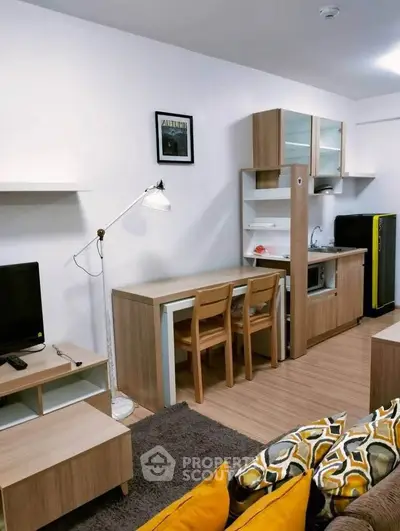 Modern studio apartment with compact kitchen and cozy living area, featuring stylish wooden furniture and vibrant decor.