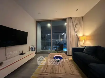 Modern living room with cozy seating and large window offering city view