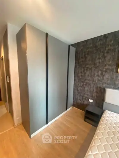 Modern bedroom with sleek wardrobe and stylish decor