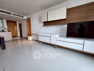 Spacious modern living room with sleek furniture and glossy tiled floor