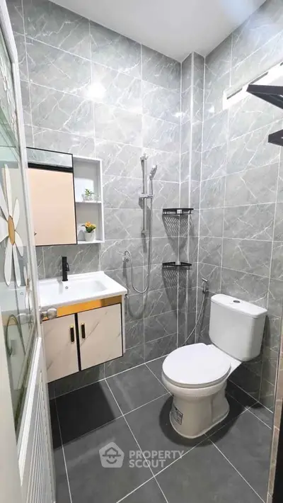 Modern bathroom with sleek gray tiles and contemporary fixtures