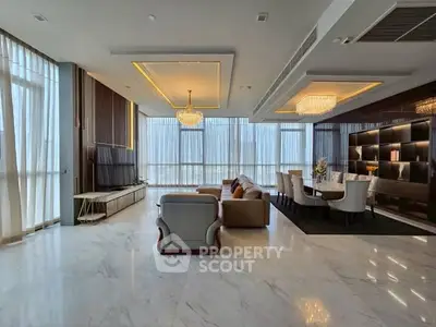 Luxurious living room with elegant chandeliers and floor-to-ceiling windows.