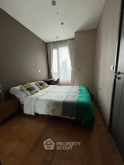 Cozy bedroom with modern decor and large window for natural light