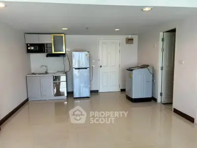 Spacious kitchen area with modern appliances and sleek design