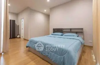 Spacious bedroom with modern decor and cozy ambiance