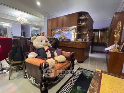 Luxurious living room with elegant decor and plush teddy bear on ornate sofa.